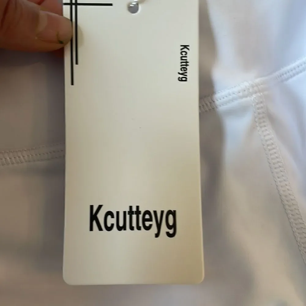 Kcutteyg white exercise capris with side pockets.  New with tags